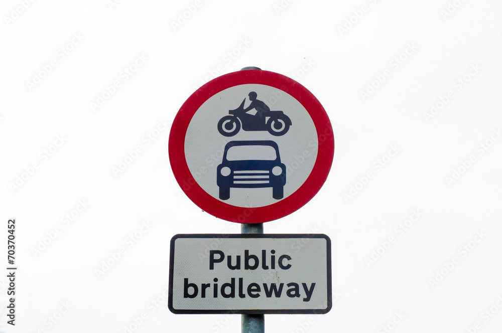 Closeup on public bridleway red and white sign post