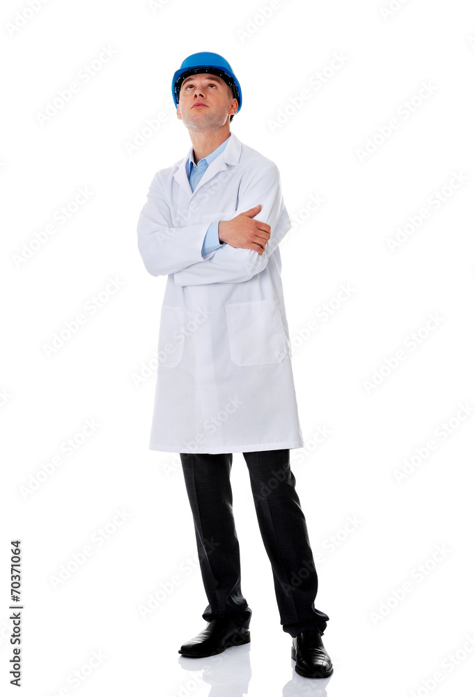 Man in a lab coat and helmet