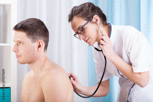 Photos Doctor auscultating patient