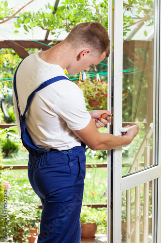 Free Download Handyman adjusting a window handle - GFXLoad