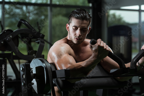 Young Man Doing Heavy Weight Exercise For Biceps
