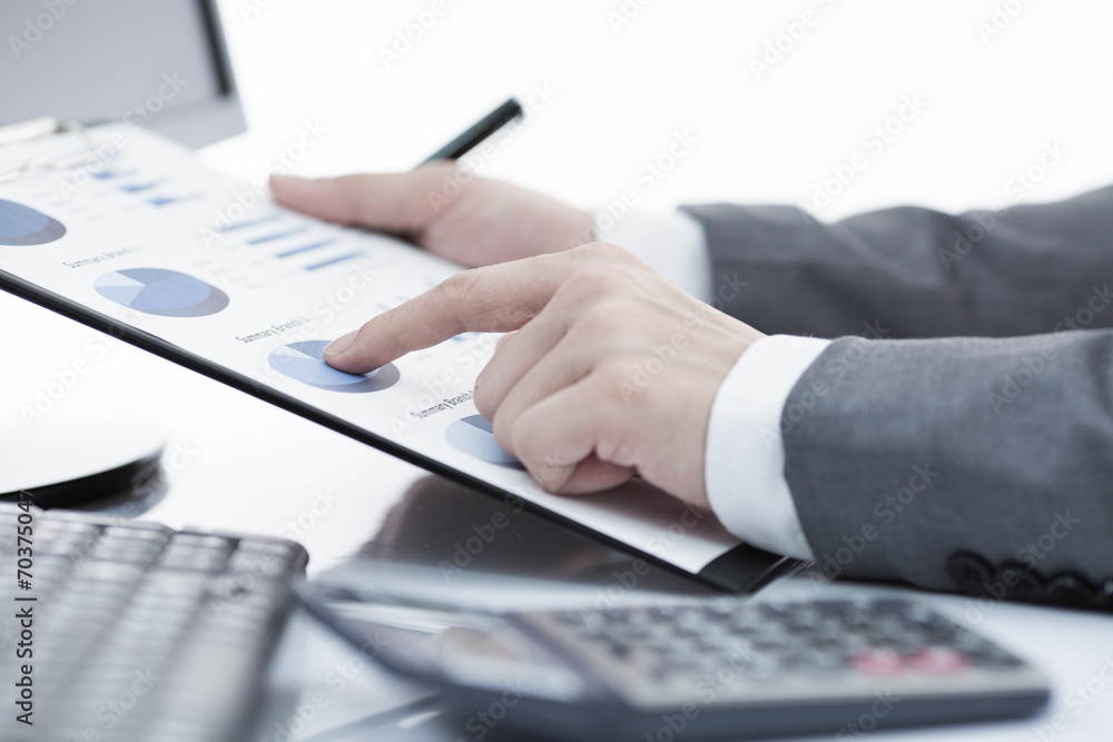Businessman analyzing investment charts with computer. Accountin Businessman analyzing investment charts with computer. Accountin