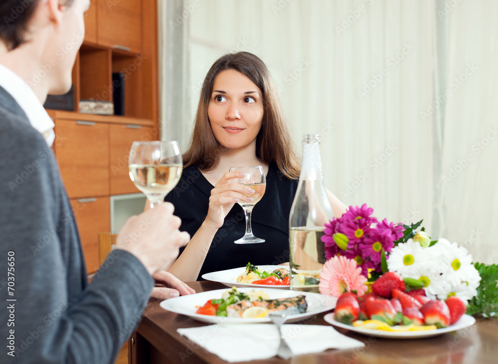 Young women having romantic dinner with her husband