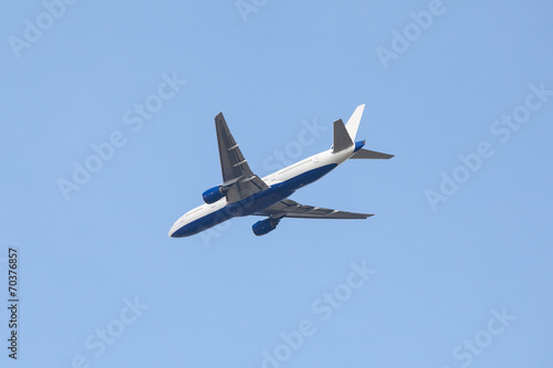 Aircraft flying in blue sky