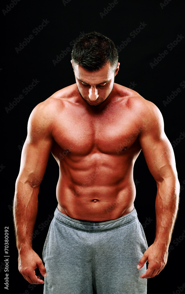 Portrait of a muscular man isolated on a black background Portrait of a muscular man isolated on a black background