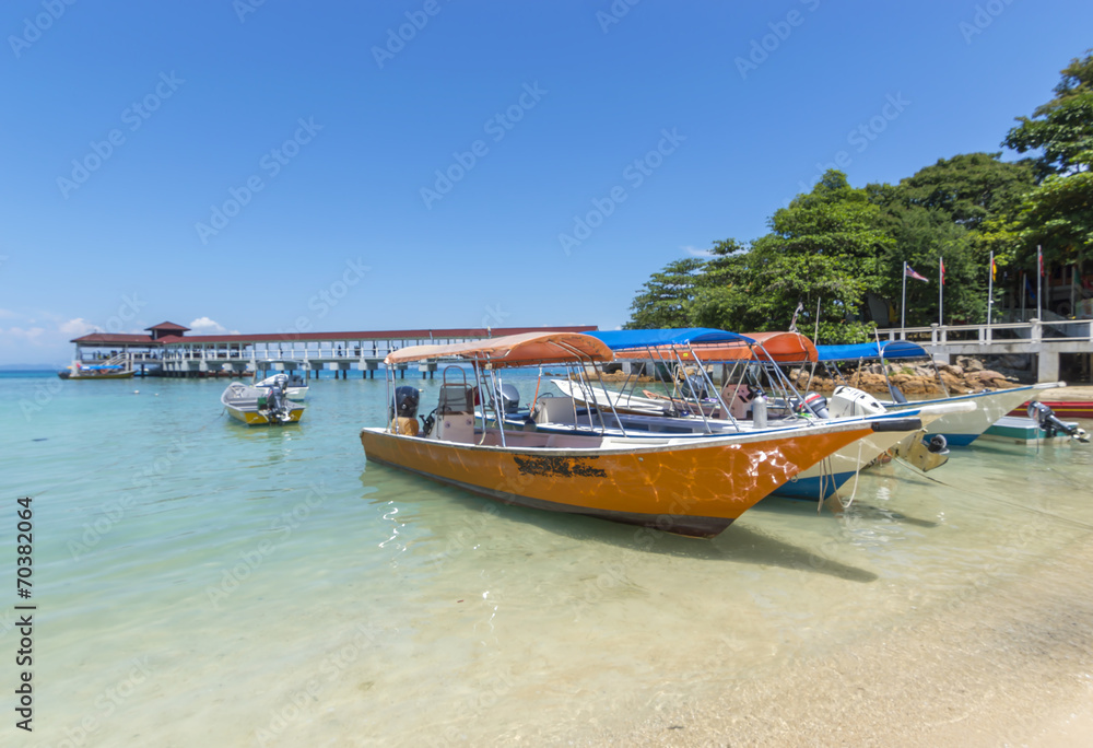 Boats with clear water and blue skies