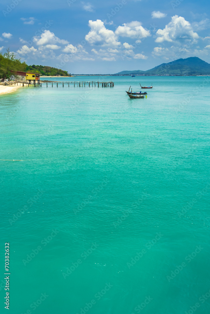 fishing boat floating in the sea on blue sky background. fishing boat floating in the sea on blue sky background.
