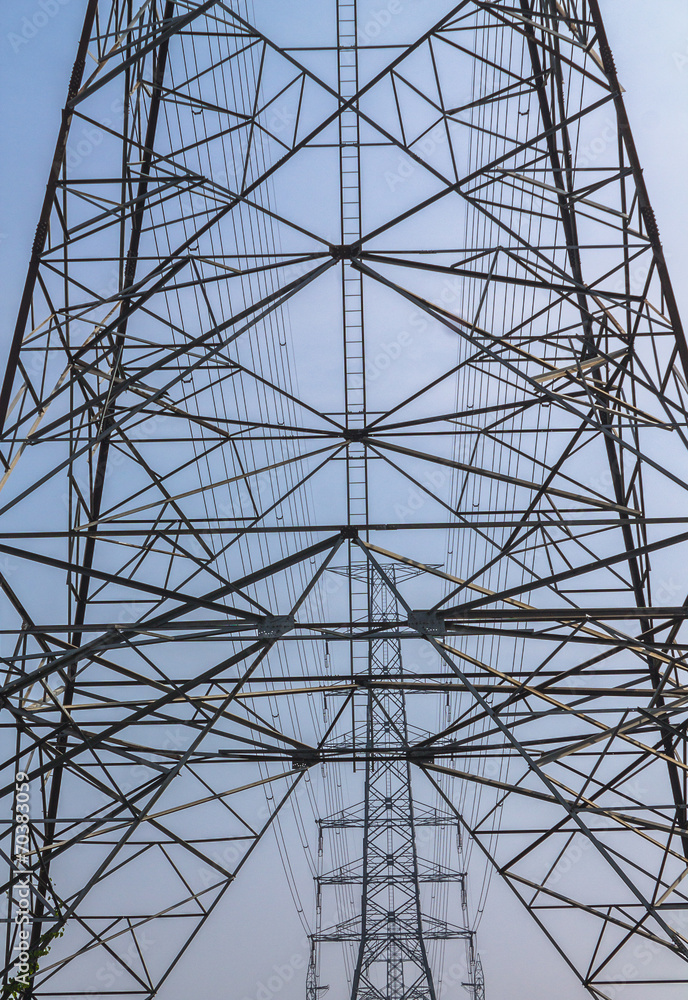 High-voltage tower on blue sky background.