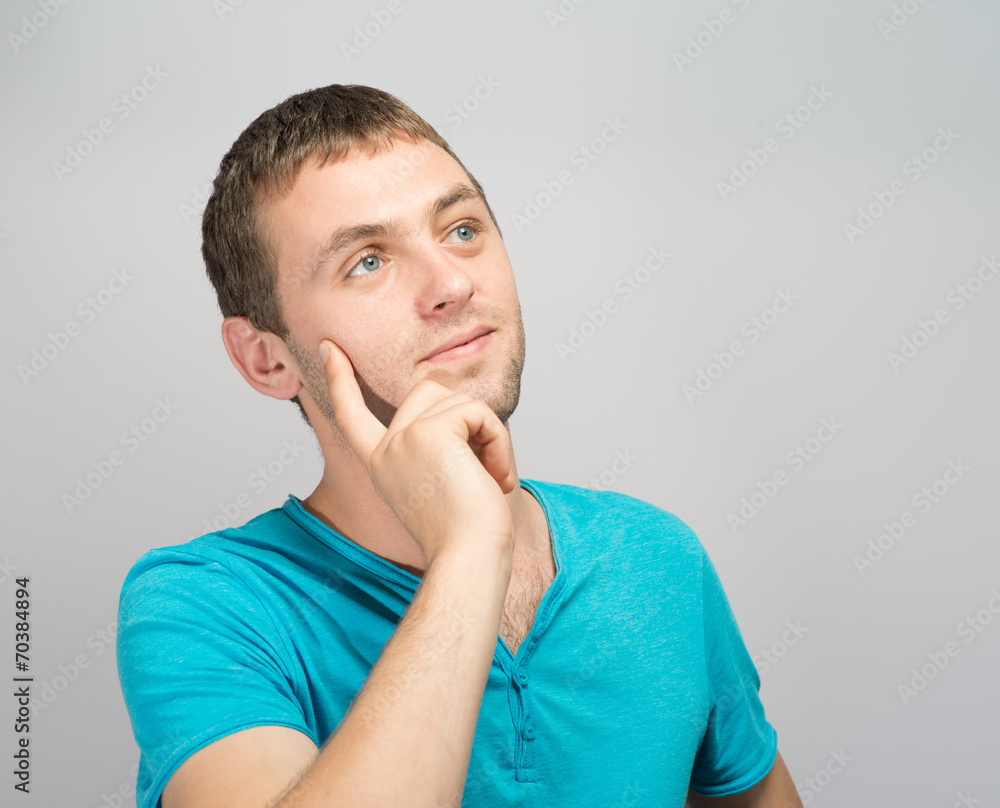 Portrait of a young businessman holding his chin with his hand. Portrait of a young businessman holding his chin with his hand.