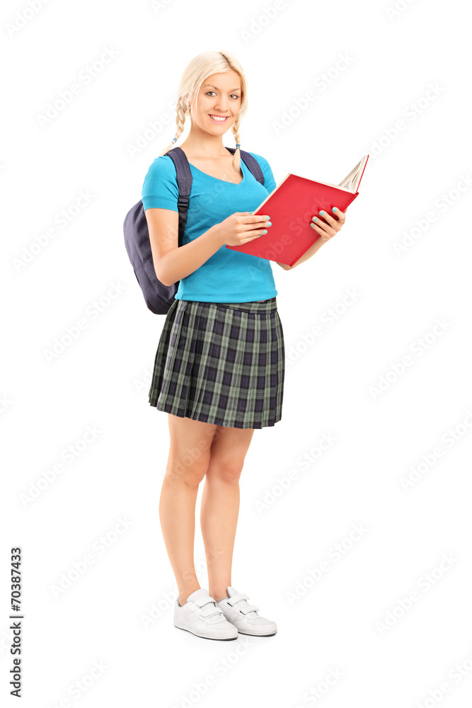 Female student reading from a notebook Female student reading from a notebook