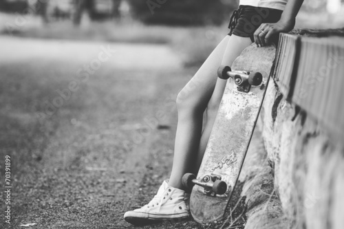 Beautiful skater girl in summer city