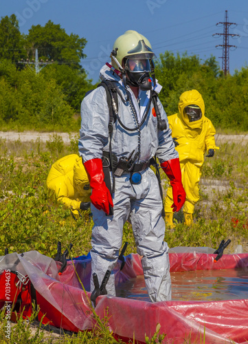 Hazmat team members have been wearing protective suits photo