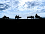 silhouette people bench sea