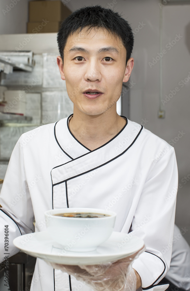 Japanese chef preparing a meal in a restaurant Japanese chef preparing a meal in a restaurant