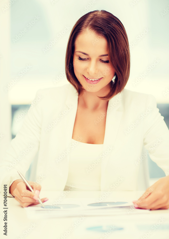 businesswoman working with graphs in office businesswoman working with graphs in office