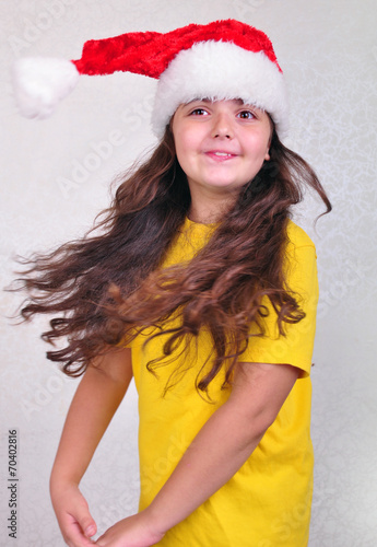 child with Santa Claus red hat photo