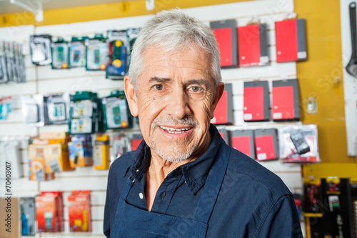 Confident Senior Worker Smiling In Hardware Shop