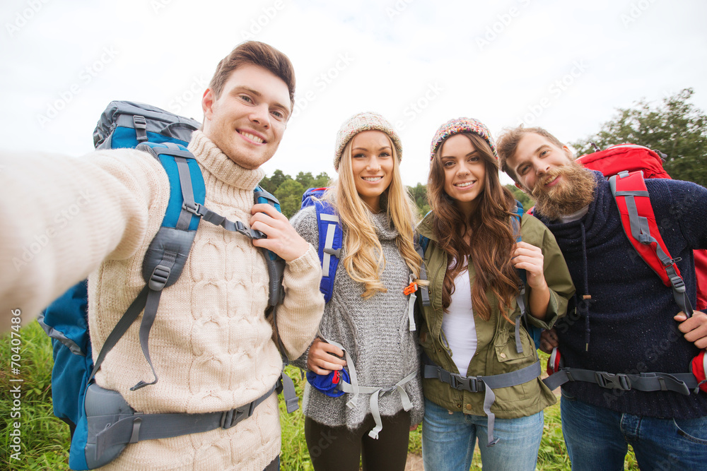 group of smiling friends with backpacks hiking group of smiling friends with backpacks hiking