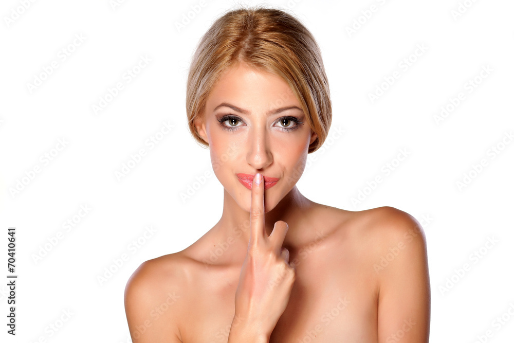 beautiful young blonde kissing her finger on white backgrounde beautiful young blonde kissing her finger on white backgrounde