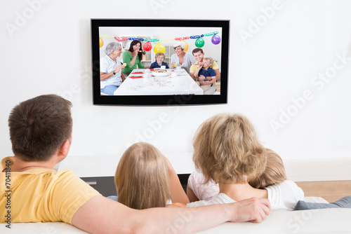 Young Family Watching TV Together