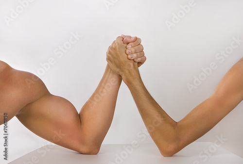 Two hands clasped arm wrestling (strong and weak), Unequal match