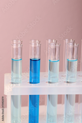 Test tubes with liquid on grey background