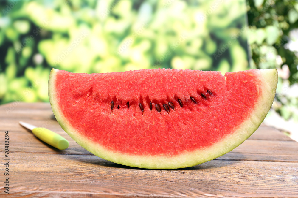 Fresh slice of watermelon on table outdoors, close up Fresh slice of watermelon on table outdoors, close up