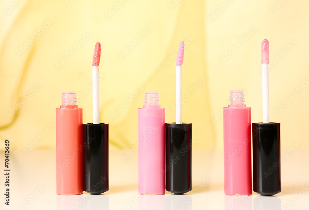 Beautiful lip glosses on color background Beautiful lip glosses on color background