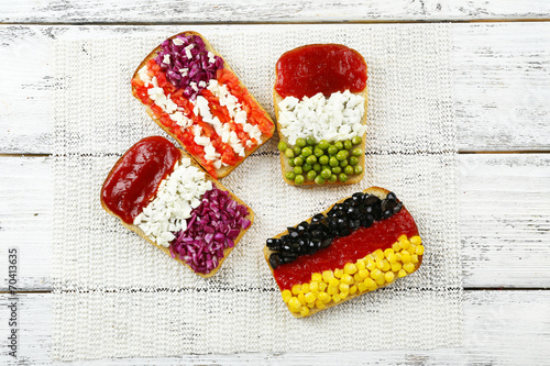 Sandwiches with  different flags on table close-up