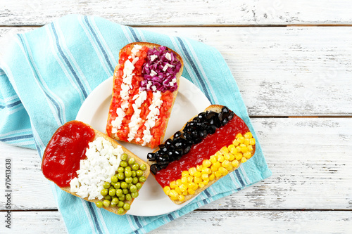Sandwiches with  different flags on table close-up