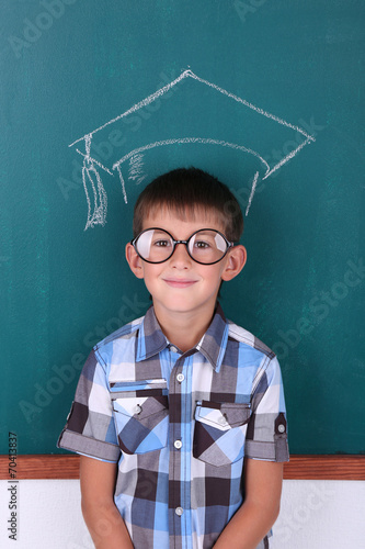 Schoolboy at blackboard in ...