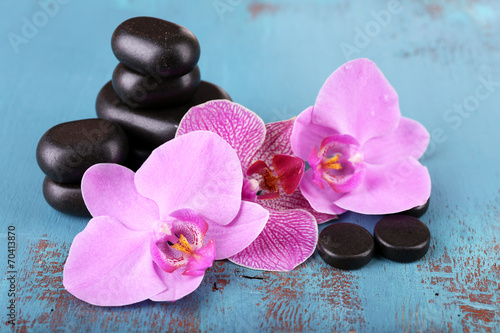 Pink tropical orchid flowers and spa stones