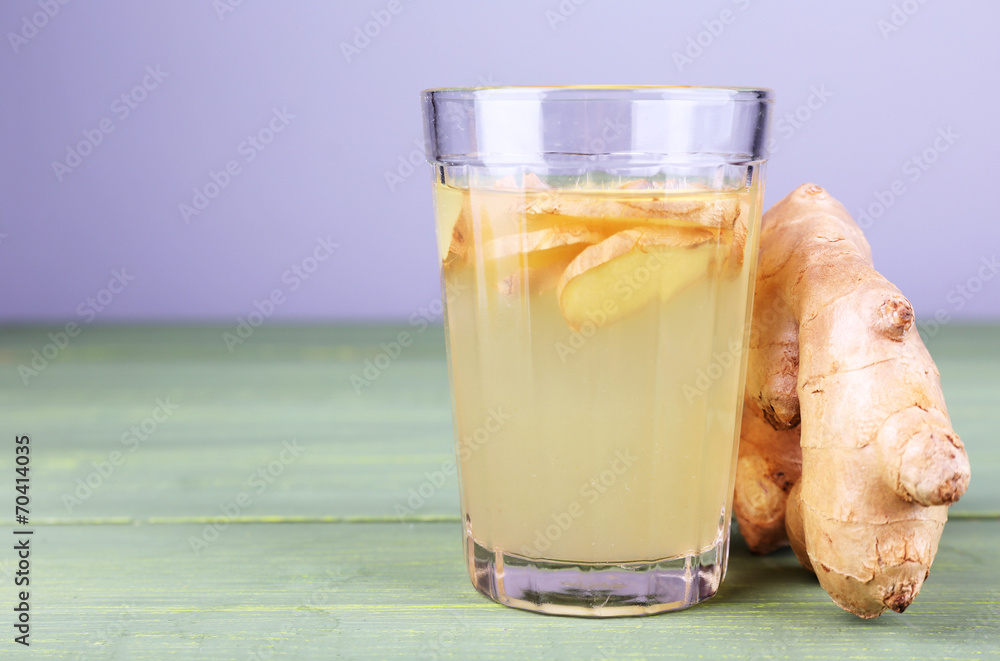Ginger drink on wooden table on light background Ginger drink on wooden table on light background