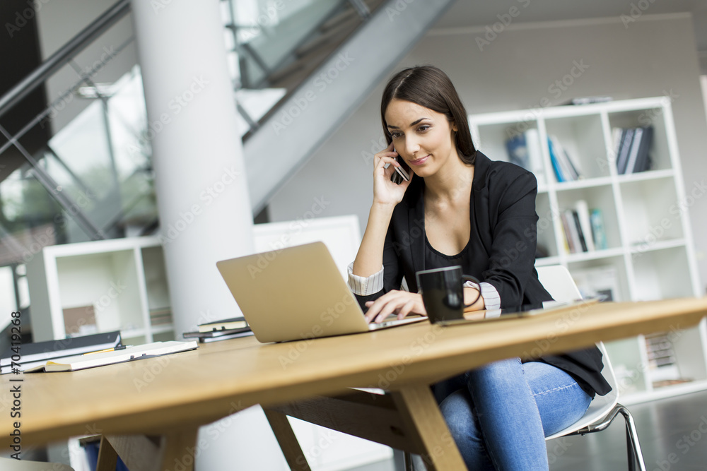 Fototapeta premium Young woman in the office