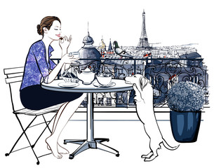 Woman having breakfast on a balcony in Paris