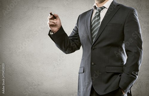 Young businessman holding lecture, drawing smth on the screen photo