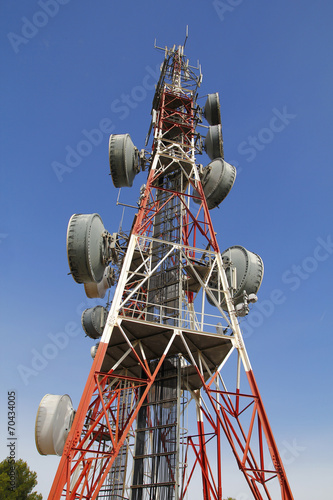 Telecommunications tower against blue sky