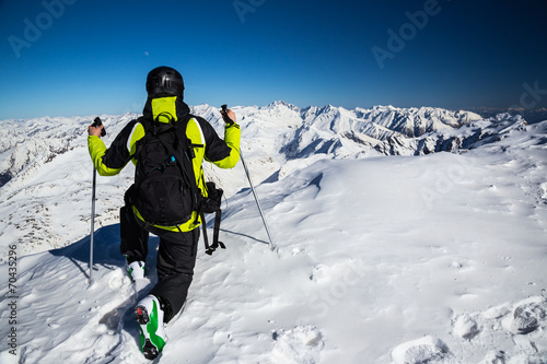 Adventurer on the top of alpine mountains