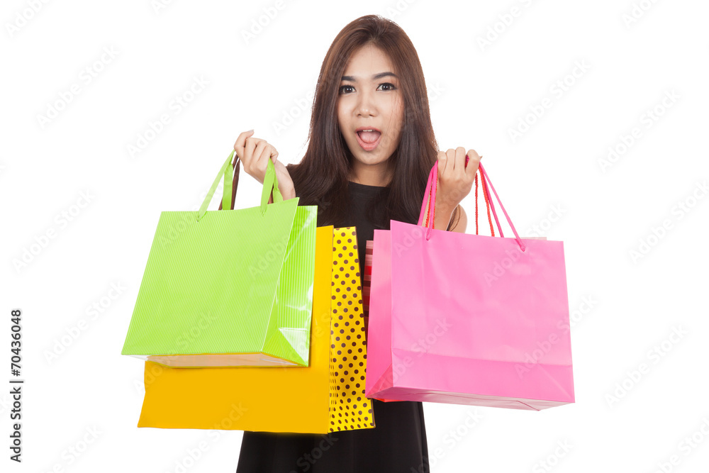 Beautiful Asian woman shocked with  shopping bags in both hands
