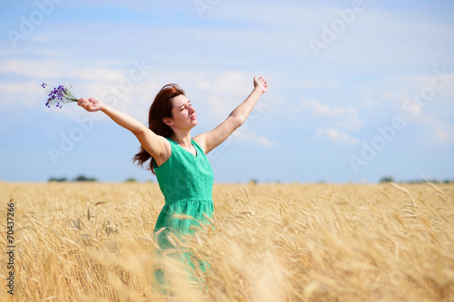 Woman enjoying nature on wheat field