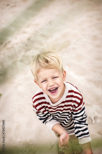happy laughing child on the beach. Oudoor portrait