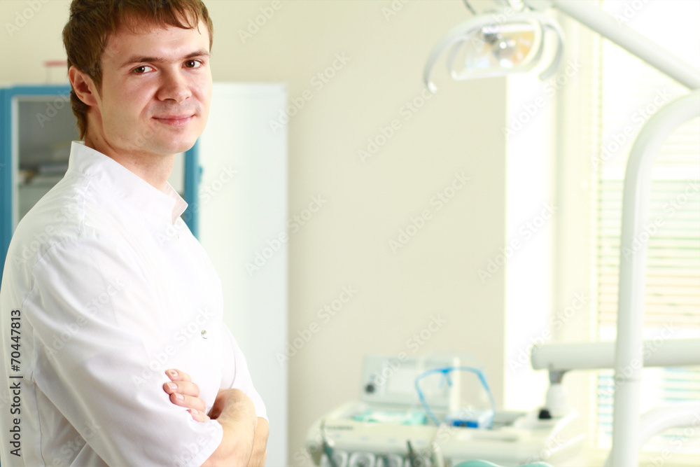 Man dentist at his office smiling Man dentist at his office smiling