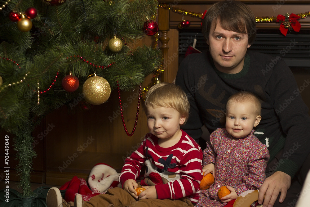 Happy family with baby under decorated Christmas Tree, gifts Happy family with baby under decorated Christmas Tree, gifts