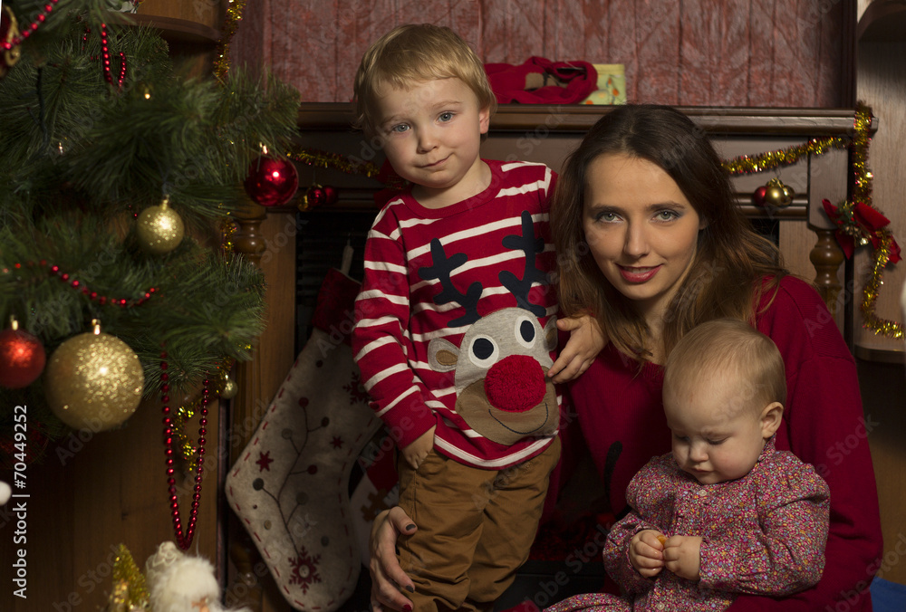 Happy family with baby under decorated Christmas Tree, gifts Happy family with baby under decorated Christmas Tree, gifts