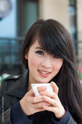 Pretty young woman drink coffee