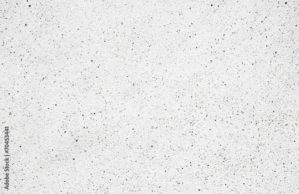 White cement wall with tiny rock on surface, grunge background. White cement wall with tiny rock on surface, grunge background.