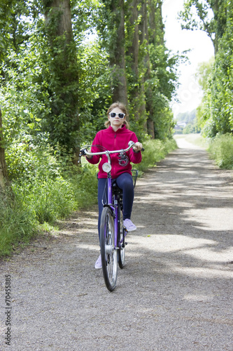 young girl with her bicycle photo