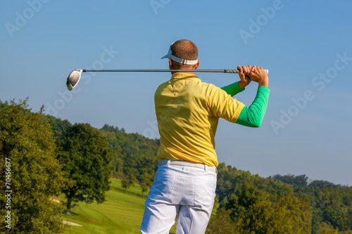  Man playing golf against blue sky
