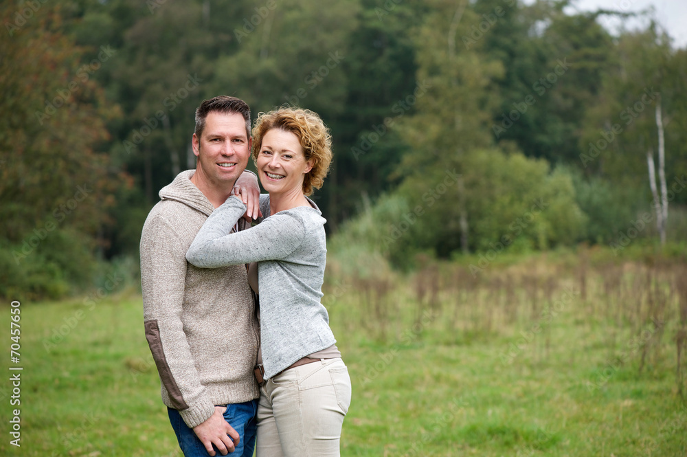 Happy couple smiling and hugging outdoors Happy couple smiling and hugging outdoors