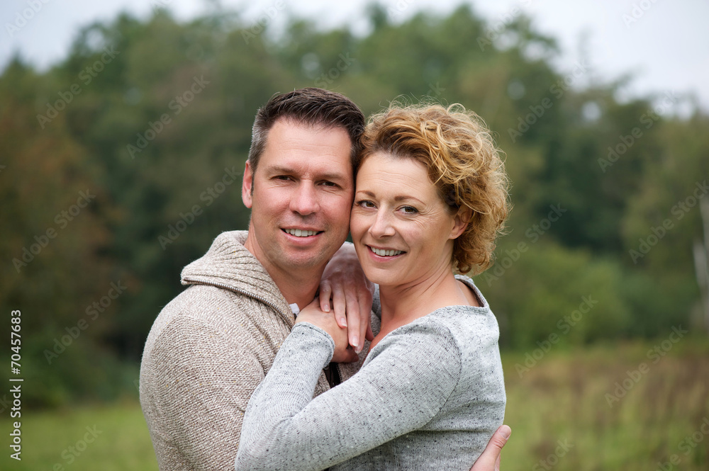 Smiling couple hugging outdoors